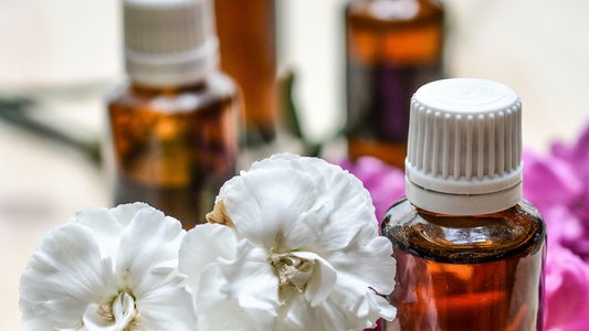Bottles of essential oils and flowers