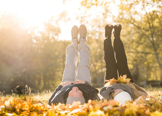 Couple laying in the fall leaves