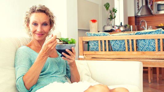 Woman enjoying a Keto-Green snack in a bowl