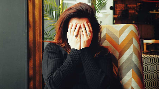 Woman with her face in her hands