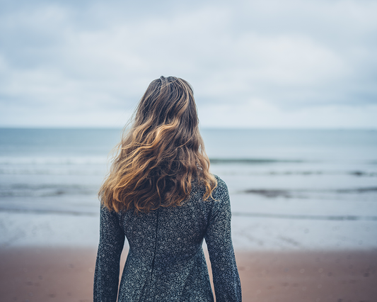 Woman staring out at the ocean