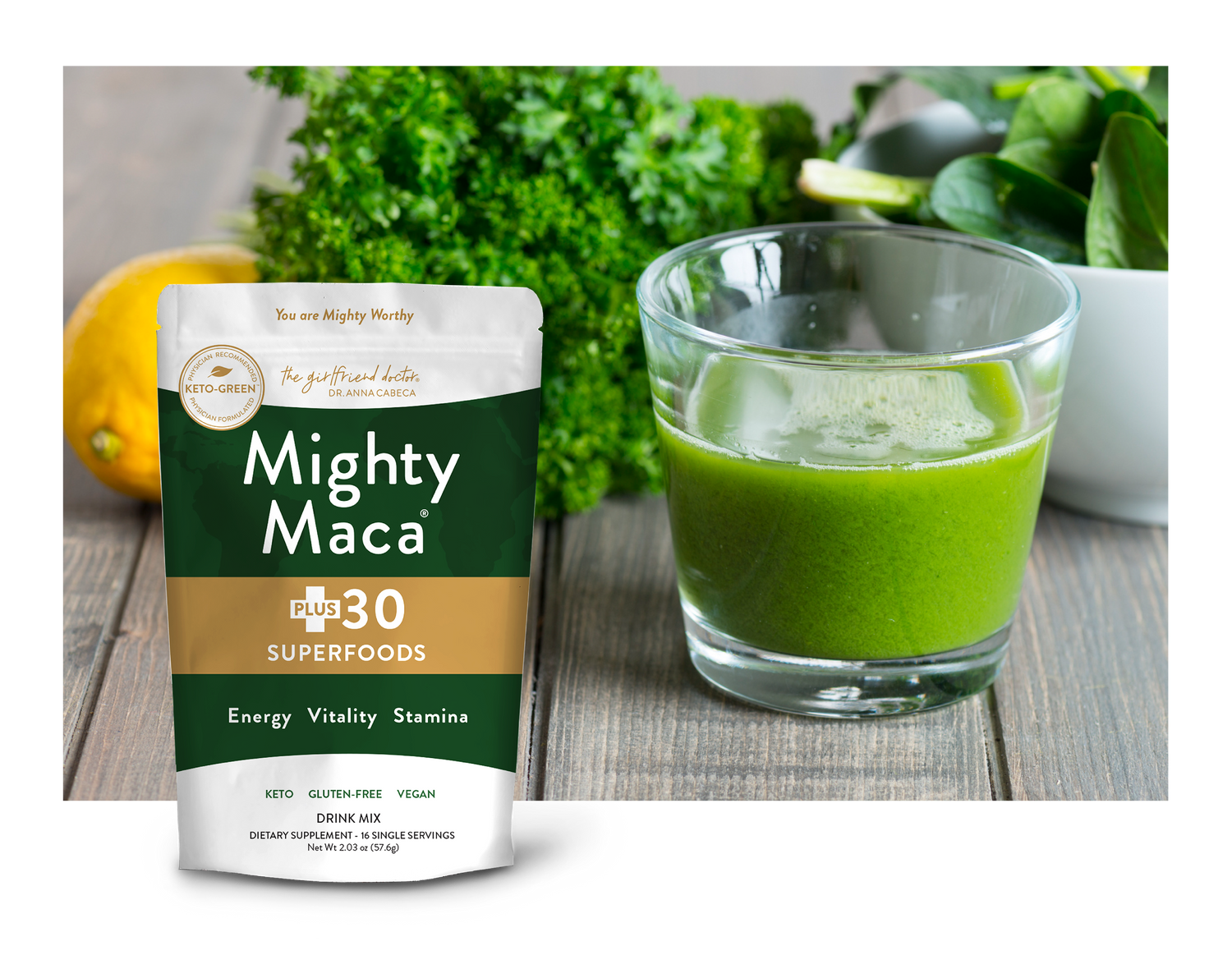 Bag of Mighty Maca Plus 16 Servings next to a glass containing a green drink