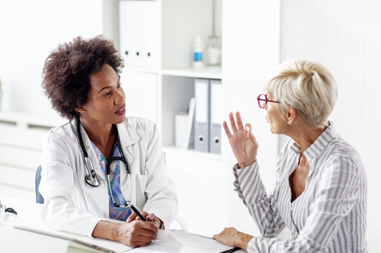 woman with silver hair consulting with her doctor