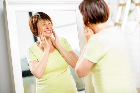 Woman happily looking in the mirror