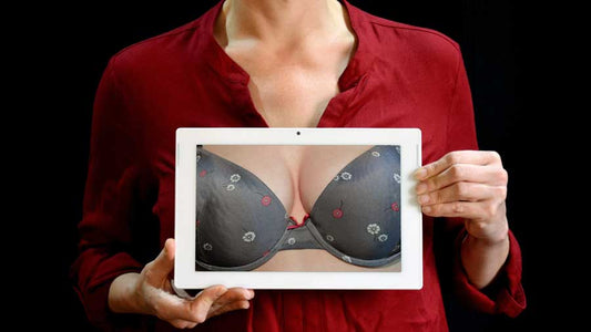 Breast cancer - what you may not know. Woman holding image of breasts in front of her chest