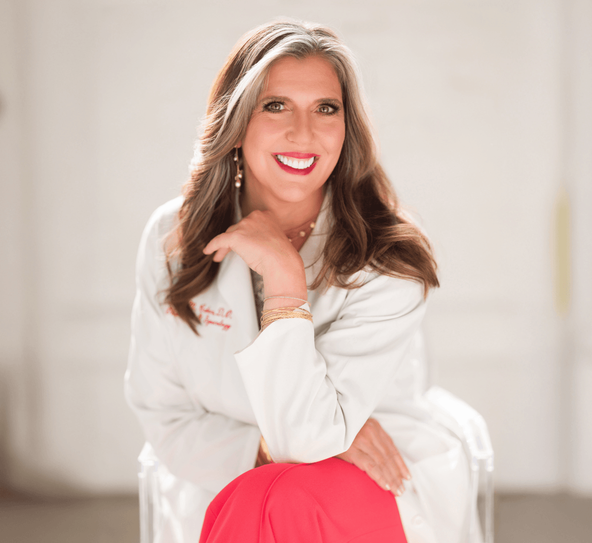 Dr. Anna Cabeca sitting, smiling