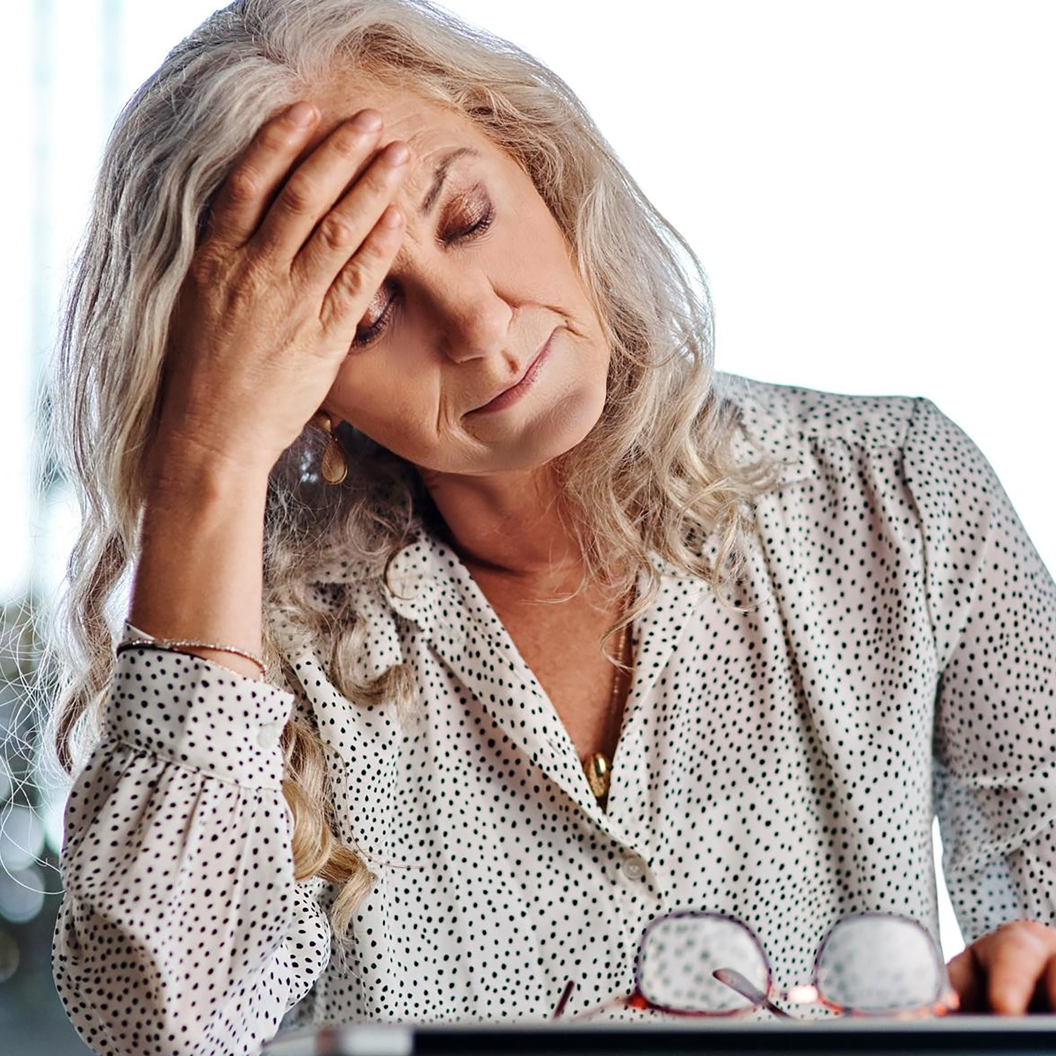 Older woman deep in thought